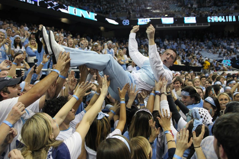 Clay Browning, a former graduate assistant coach for UNC football, crowd surfs in the bleacher level student section of the Dean Smith Center before the UNC men's basketball game vs. Duke on March 4, 2017.