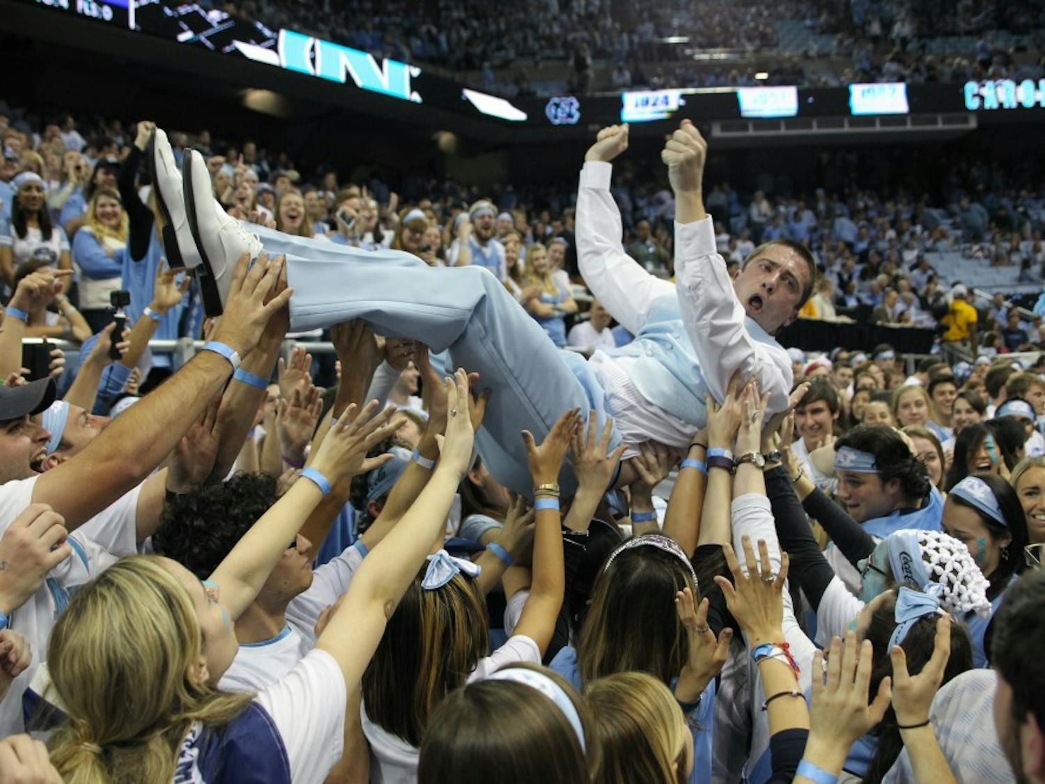 Clay Browning, a former graduate assistant coach for UNC football, crowd surfs in the bleacher level student section of the Dean Smith Center before the UNC men's basketball game vs. Duke on March 4, 2017.