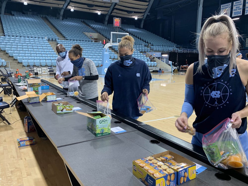 UNC women's basketball players make snack bags for TABLE. Photo courtesy of UNC Women's Basketball.