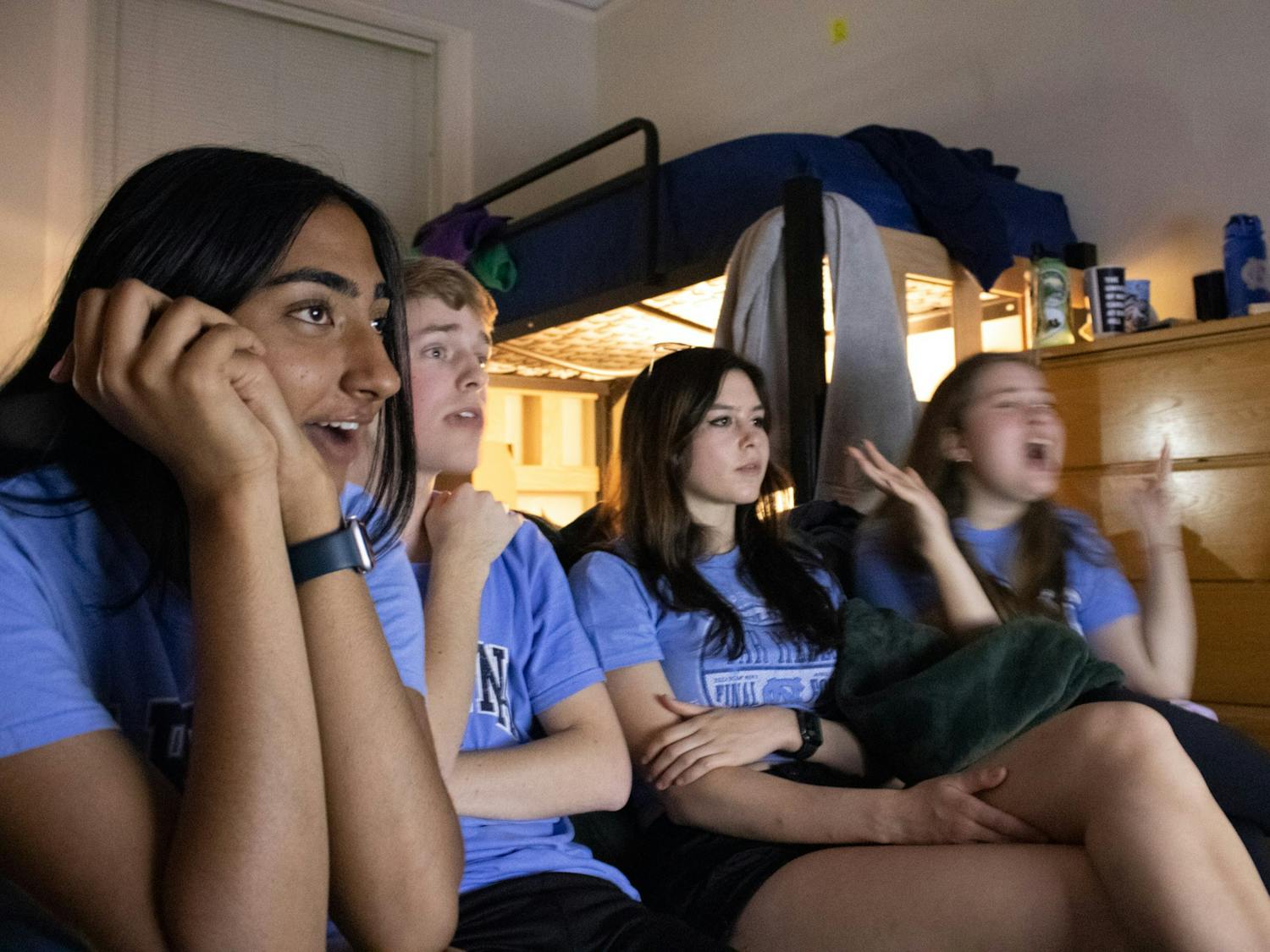 UNC Freshmen (from left to right) Nikita Umesh, Austin Foushee, Sayde Friedman, and Celia Gibbs watch the NCAA Basketball Final Game between UNC and Kansas in Alexander Residential Hall on Monday, April 4 2022.
