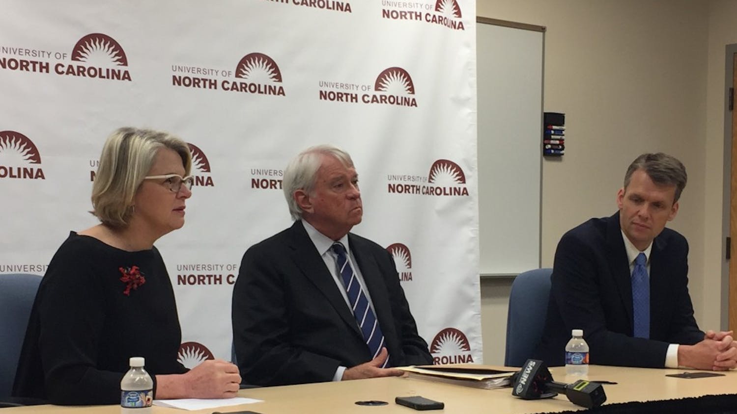Spellings, BOG Chairperson Lou Bissette and UNC-system general counsel Thomas Shanahan speak to reporters in a press conference.