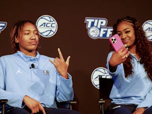 North Carolina's Kennedy Todd-Williams, left, and Deja Kelly take a selfie at the 2022 ACC Tipoff in Charlotte, N.C., Tuesday, Oct. 11, 2022. (Photo by Nell Redmond/ACC)