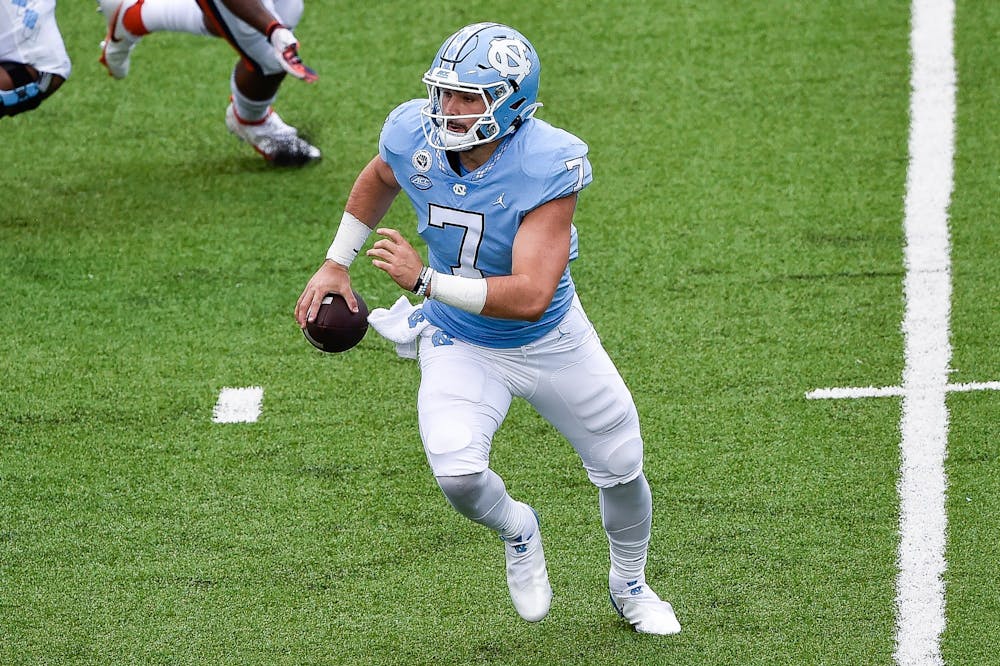 UNC sophomore quarterback Sam Howell (7) prepares to run the ball during a game against Syracuse in Kenan Memorial Stadium on Sept. 12, 2020. UNC beat Syracuse 31-6.