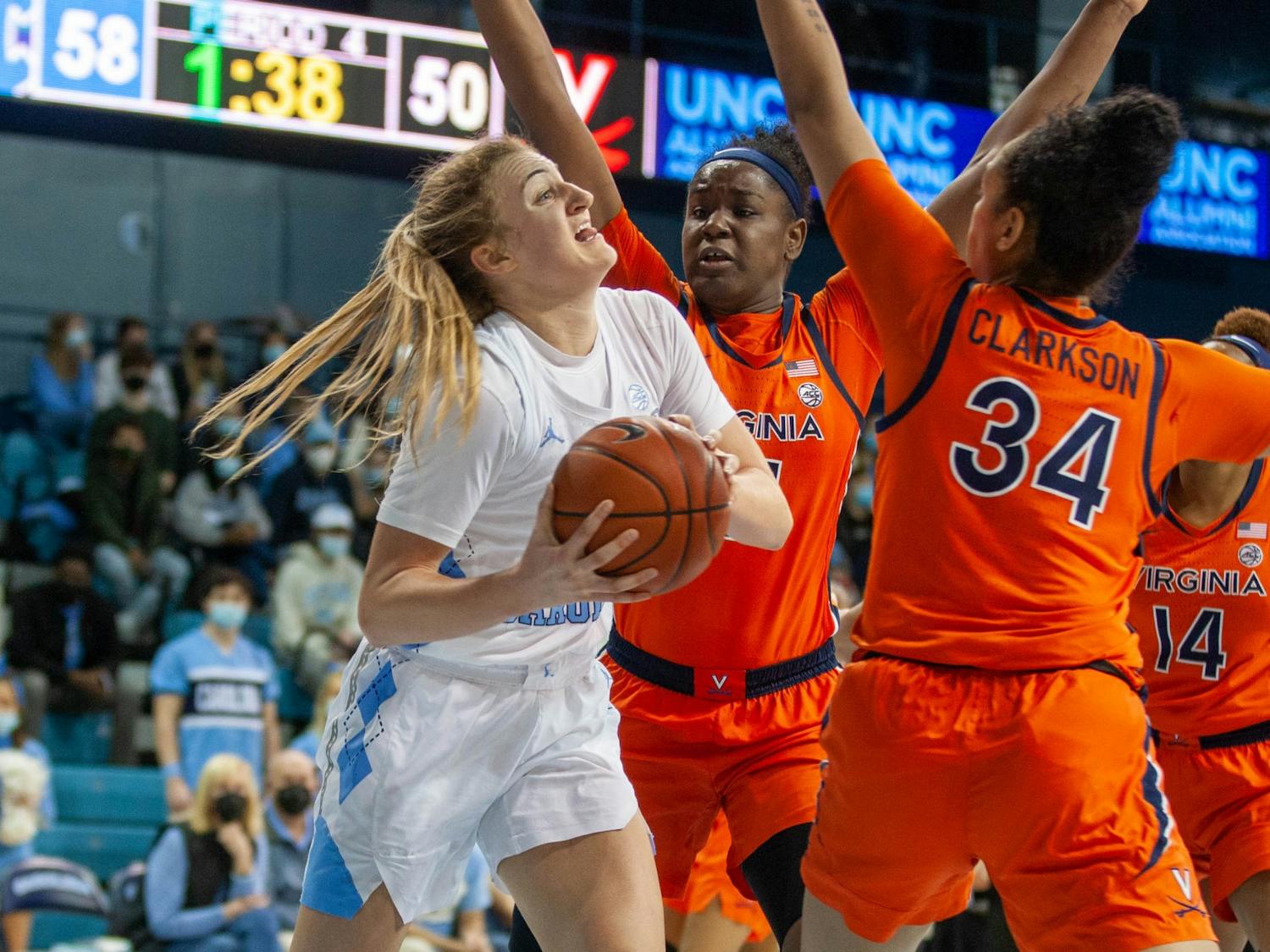 UNC sophomore guard Alyssa Utsby (1) is guarded by UVA players at the game against Virginia at Carmichael Arena on Jan. 20 2022. The Tar Heels beat the Cavliers 61-52.