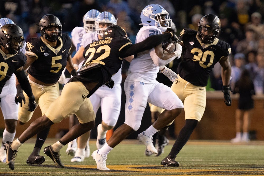 Sophomore running back Elijah Green (21) carries the ball down the field during the first half of UNC's game against Wake Forest at Truist Field on Saturday, Nov. 12, 2022.