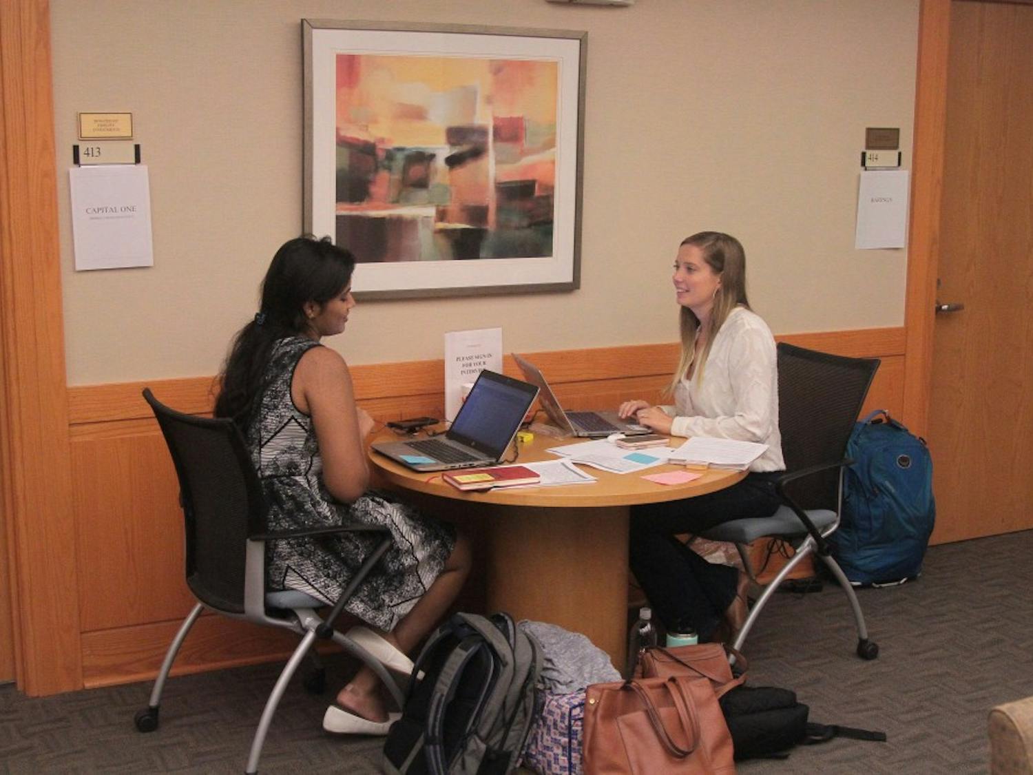Alexis Barron (right) and Sri Sure (left) manage interviews at the University Career Services Center on the 4th floor of Hanes hall on Wednesday, Sept. 26, 2018.