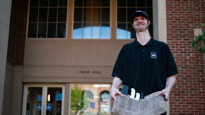 Sam Wagner poses for a portrait outside of Chase Dining Hall. he has been awarded by Chef Hunter Stegall for his hard work and dedication in food preparation.
