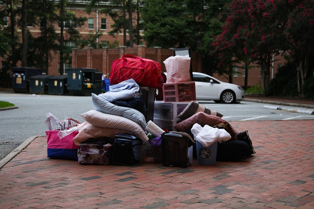 Items from a student's dorm sits in a pile outside Hinton James Residence Hall on Tuesday, Aug. 18, 2020. Students began to move out of various residence halls on campus after the announcement that all undergraduate classes would be moving online for the Fall 2020 semester.
