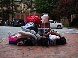 Items from a student's dorm sits in a pile outside Hinton James Residence Hall on Tuesday, Aug. 18, 2020. Students began to move out of various residence halls on campus after the announcement that all undergraduate classes would be moving online for the Fall 2020 semester.