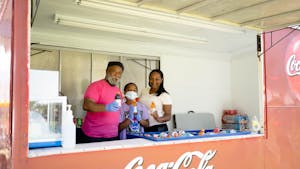 Reverend Robert Cambell, Robin McClain and Noahh McClain provide cold beverages in front of Hargraves Community Center at the Chapel Hill-Carrboro Juneteenth Celebration on Sunday, June 19, 2022.
