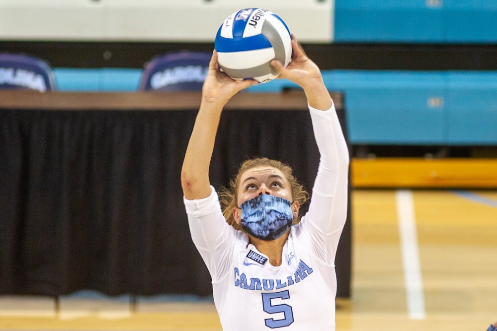 UNC Junior Annabelle Archer (5) sets the ball at the volleyball game against Virginia on Saturday, Oct. 31, 2020 at Carmichael Arena. The Tar Heels won 3-1.