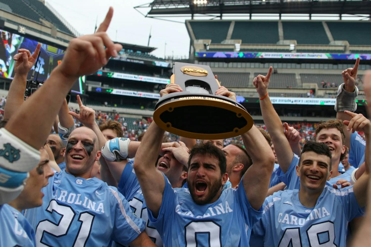 UNC attacker Steve Pontrello (0) hoists up the NCAA national championship trophy while his teammates celebrate around him.&nbsp;The unseeded North Carolina men's lacrosse team defeated No. 1 Maryland 14-13 in overtime to claim the program's first national championship since 1991 on Monday at Lincoln Financial Field in Philadelphia.