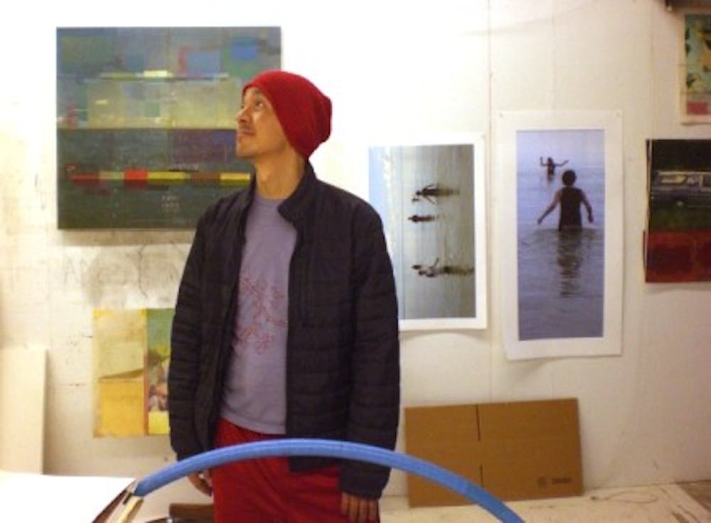 	<p>Former <span class="caps">UNC</span> associate professor Kimowan Metchewais looking at his work from within his studio. Metchewais is the featured artist of <span class="caps">LIGHT</span>: Art and Design&#8217;s gallery on display in the Greenbridge building.</p>