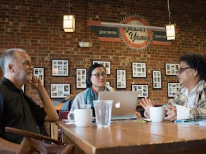 (From left) Frank Baumgartner, Jennifer Ho and Sharon Holland discuss their collaborative "Intersectionality: Race, Gender, Sexuality and Social Justice" course at the Gray Squirrel coffee shop in Carrboro in 2016. Photo courtesy of Kristen Chavez, UNC College of Arts &amp; Sciences.