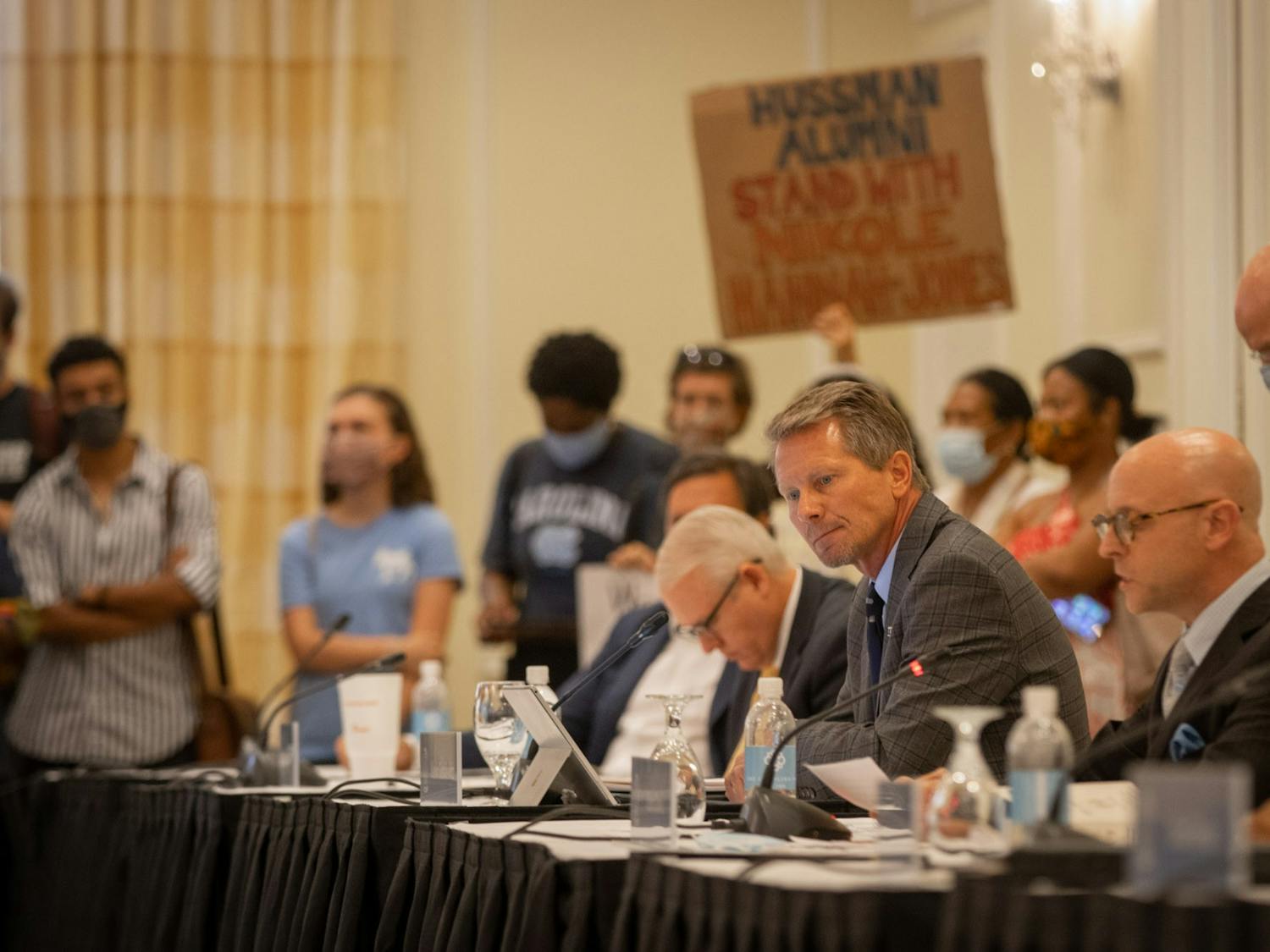 UNC Chancellor Kevin Guskiewicz looks away from protesters after the Wednesday, June 30, 2021, Board of Trustees meeting during which the Board voted to grant tenure to Nikole Hannah-Jones.