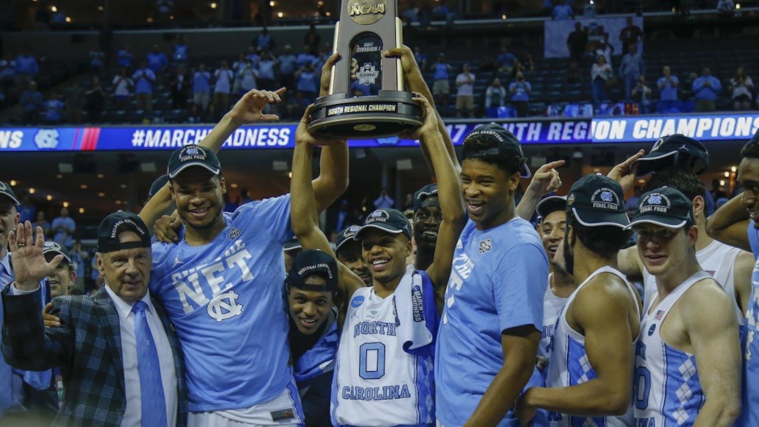 The North Carolina men's basketball team hoists up the South Regional Champion trophy fter defeating Kentucky in the Elite Eight in Memphis on Sunday.