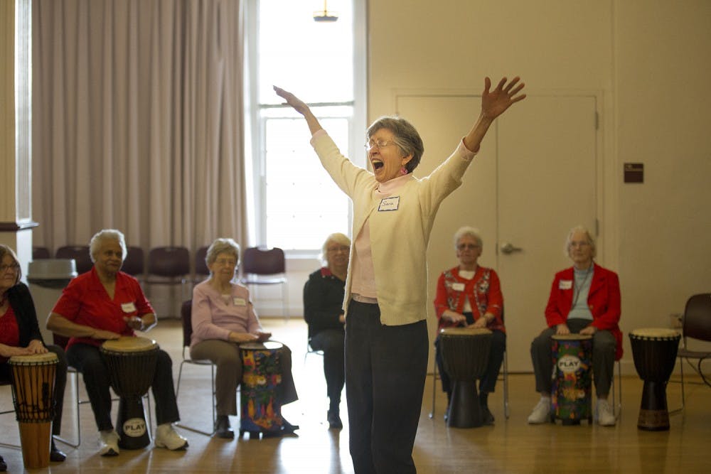 Sara Smith conducts the drum circle at the Valentines Day Party for Older Adults in Carrboro Friday afternoon.