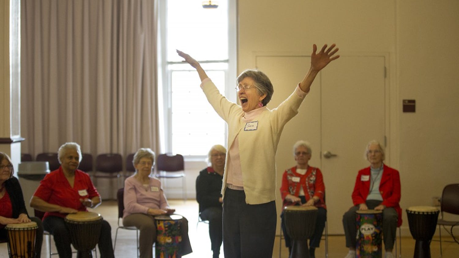 Sara Smith conducts the drum circle at the Valentines Day Party for Older Adults in Carrboro Friday afternoon.