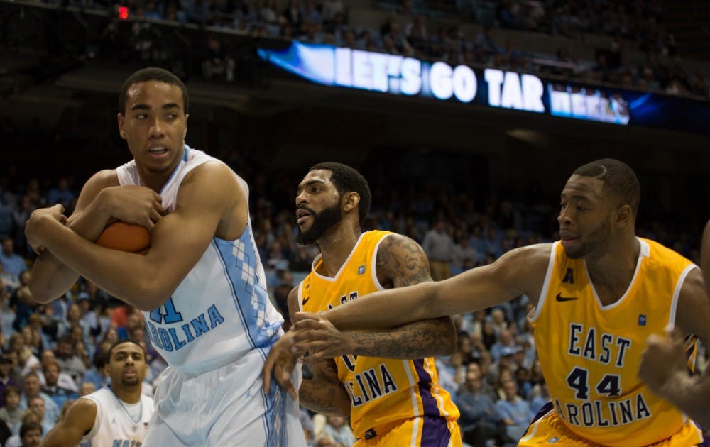 UNC forward Brice Johnson (11) tries to maintain control of the ball against East Carolina guard Terry Whisnant (00) and forward Kanu Aja (44).