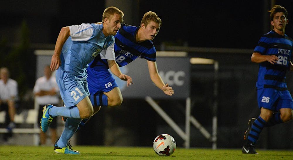 	Cooper Vandermaas-Peeler (left) chases after the ball in UNC’s 0-0 draw against Duke Friday night.