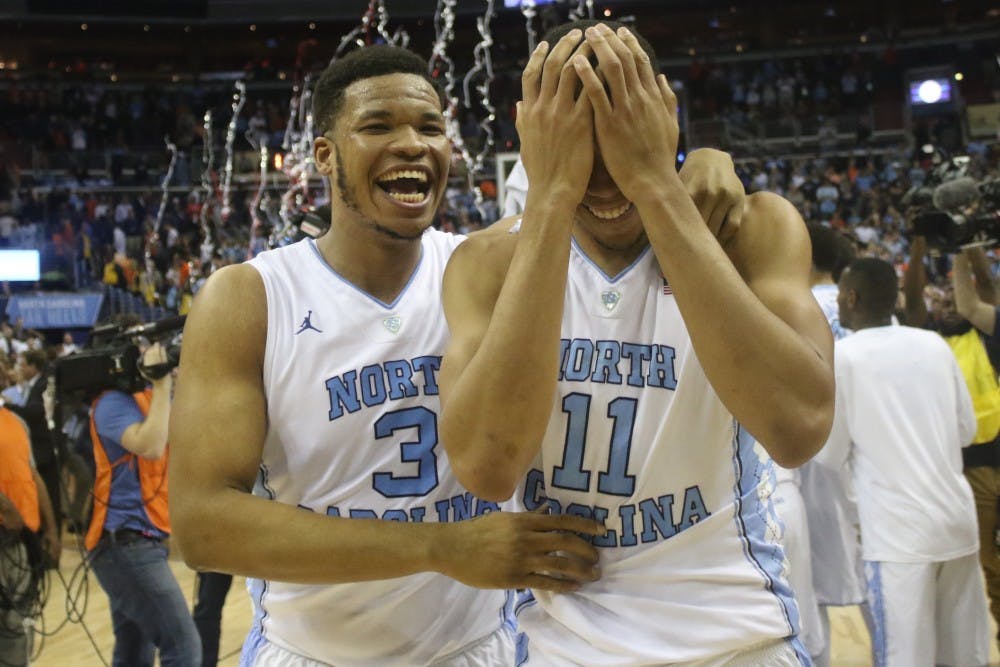 North Carolina forwards Kennedy Meeks (3) and Brice Johnson (11) react to their 61-57 victory over Virginia in Saturday's ACC&nbsp;Championship game.