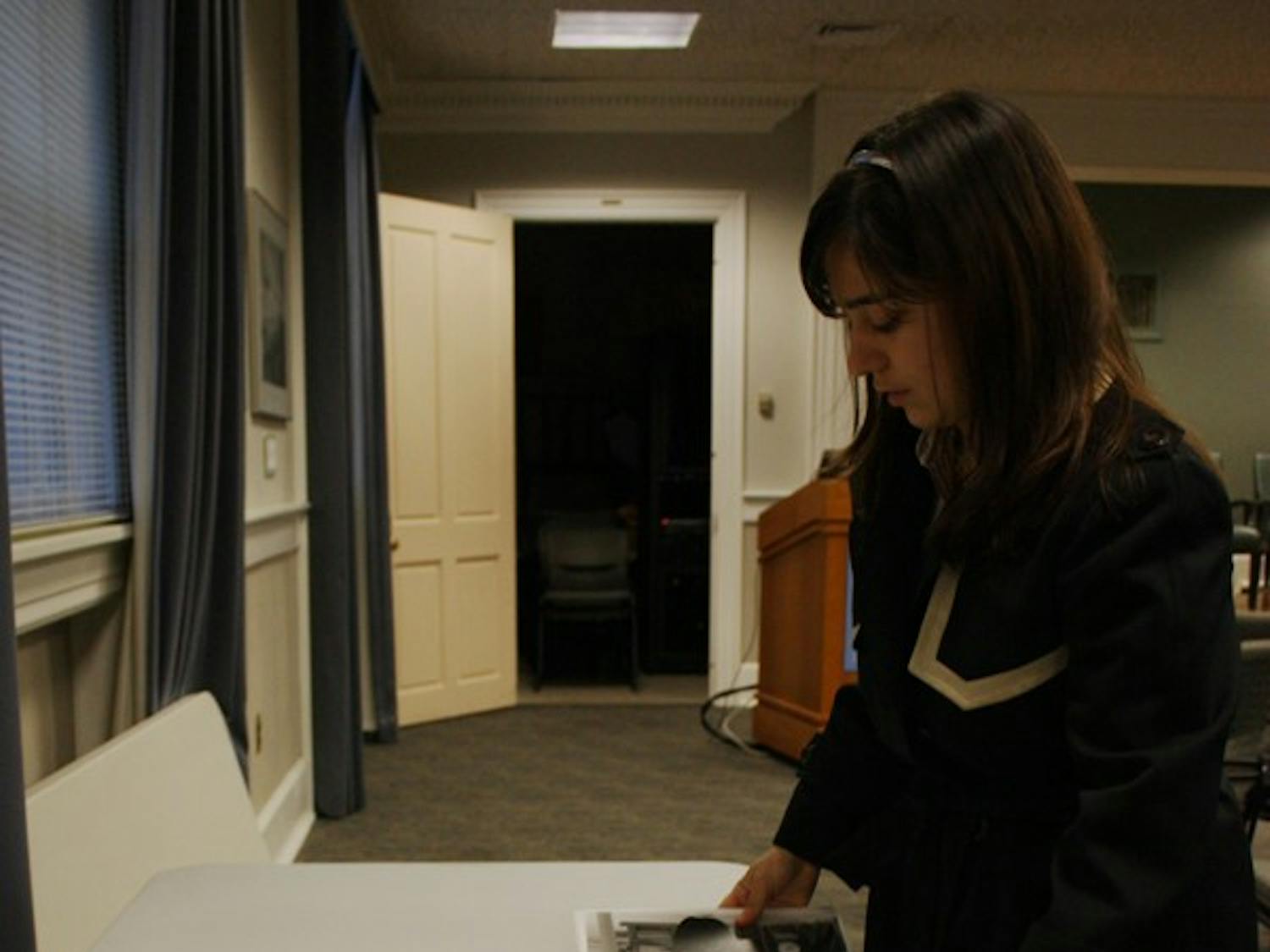 Lisa Garland, a senior sociology major, sets up her  display at the “We H(art) UNC” exhibition in Wilson Library. DTH/Daixi Xu