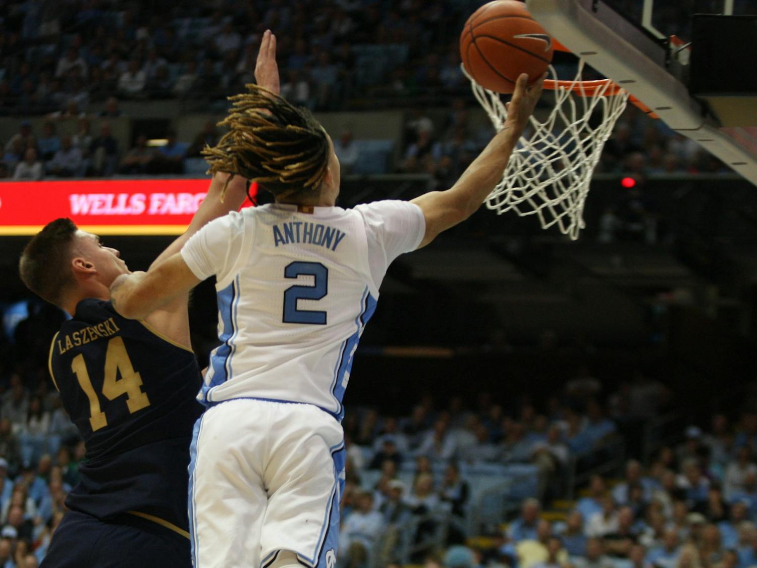 UNC guard Cole Anthony (2) drives by Notre Dame defender Nate Laszewski (14) for the layup on Wednesday, Nov. 6, 2019 in the Dean E. Smith Center. Anthony finished the game with 34 points and 11 rebounds. The Tar Heels beat the Fighting Irish 76-65.