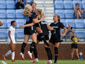 UNC players celebrate after scoring a goal at the soccer game against Washington on Thursday August 19, 2021 at the Dorrance Field.