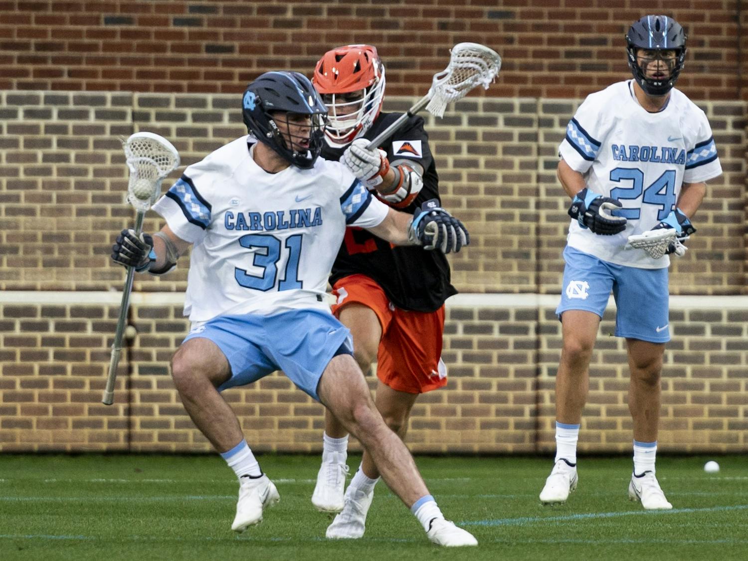 UNC graduate midfielder Connor Maher (31) protects the ball during the men’s lacrosse game against Mercer at Dorrance Field on Friday, Feb. 10, 2023. UNC won 25-3.