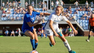 Junior defender/midfielder Avery Patterson (15) fights for the ball during UNC's second exhibition game against BYU at Dorrance Field on Saturday, Aug. 13, 2022.