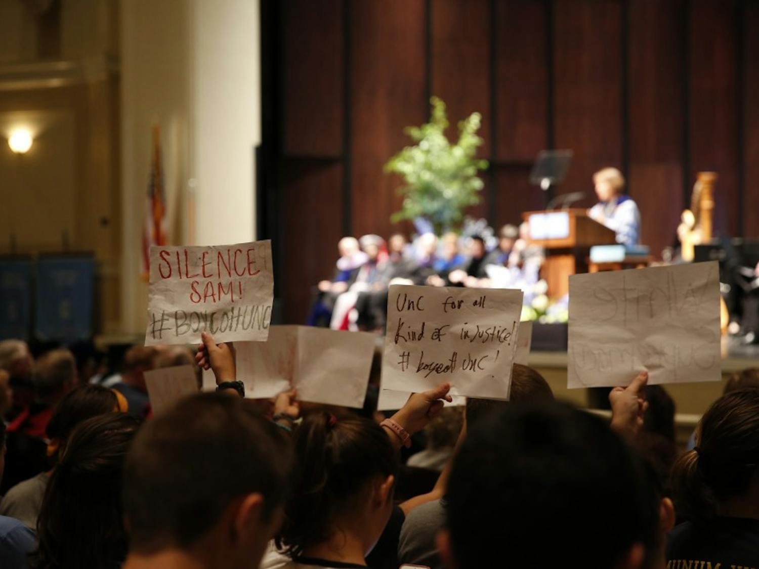 Students silently protest for Silent Sam's removal during the 2017 University Day Speech in Memorial Hall.