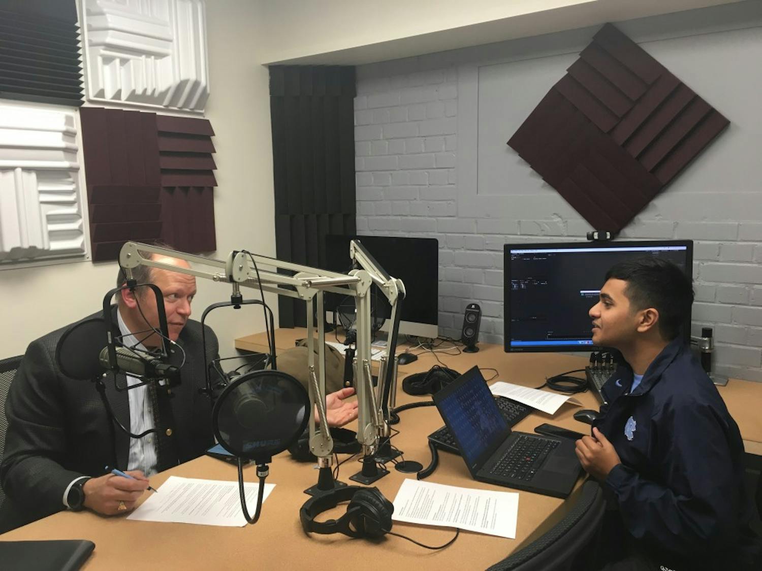 UNC alumni Akib Khan, and Ted Zoller, PhD, Director of the Entrepreneurship Center and T.W. Lewis Distinguished Clinical Professor of Strategy and Entrepreneurship, creating the On the Heels of Innovation podcast. Photo courtesy of Aspyn Fulcher. 


