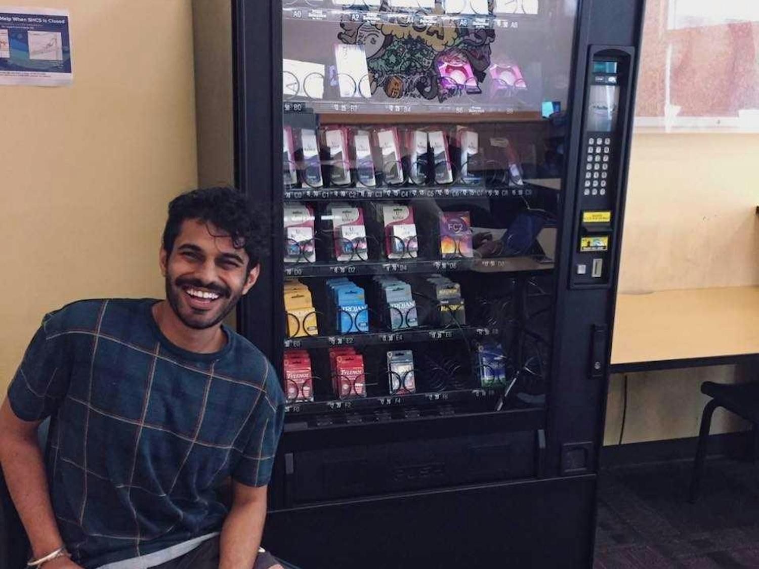 Parteek Singh poses next to the first emergency contraception vending machine at the University of California, Davis. Singh spearheaded the push for the implementation of the machines. Photo courtesy of Singh.