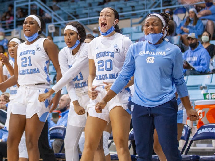 UNC women's basketball players celebrate on the bench at the game against NC A&T on Nov. 9 2021 at Carmichael Arena. UNC won 92-47.