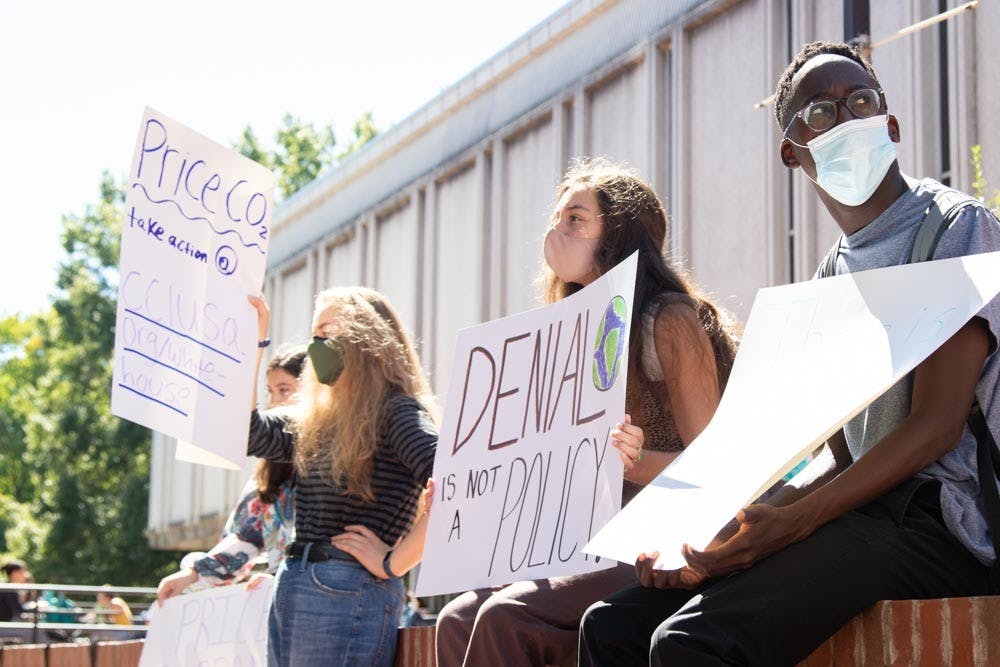 UNC students (from left to right) Jordan Brown, Caitlyn Flanagan, Marisa Romanat, and Tariro Magrira particpate in protest of UNC's coal plant in The Pit on Sep. 24, 2021.