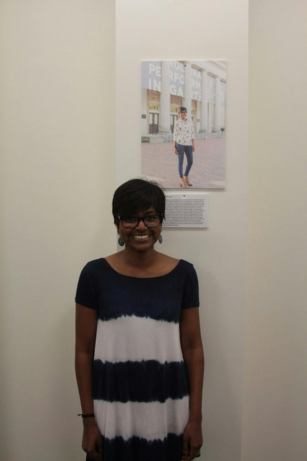 Student Sharanya Thiru poses in front of her portrait in the series of pictures as part of the "I, Too, Am Carolina" exhibit.