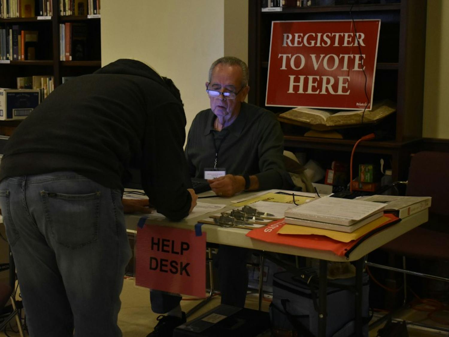 Precinct Chief Judge James Weathers volunteers at the Chapel of the Cross church at 304 E. Franklin St. on Oct. 23, 2018 helping voters register. The Chapel of the Cross severs as an early voter location close to the University of North Carolina at Chapel Hill's campus. 