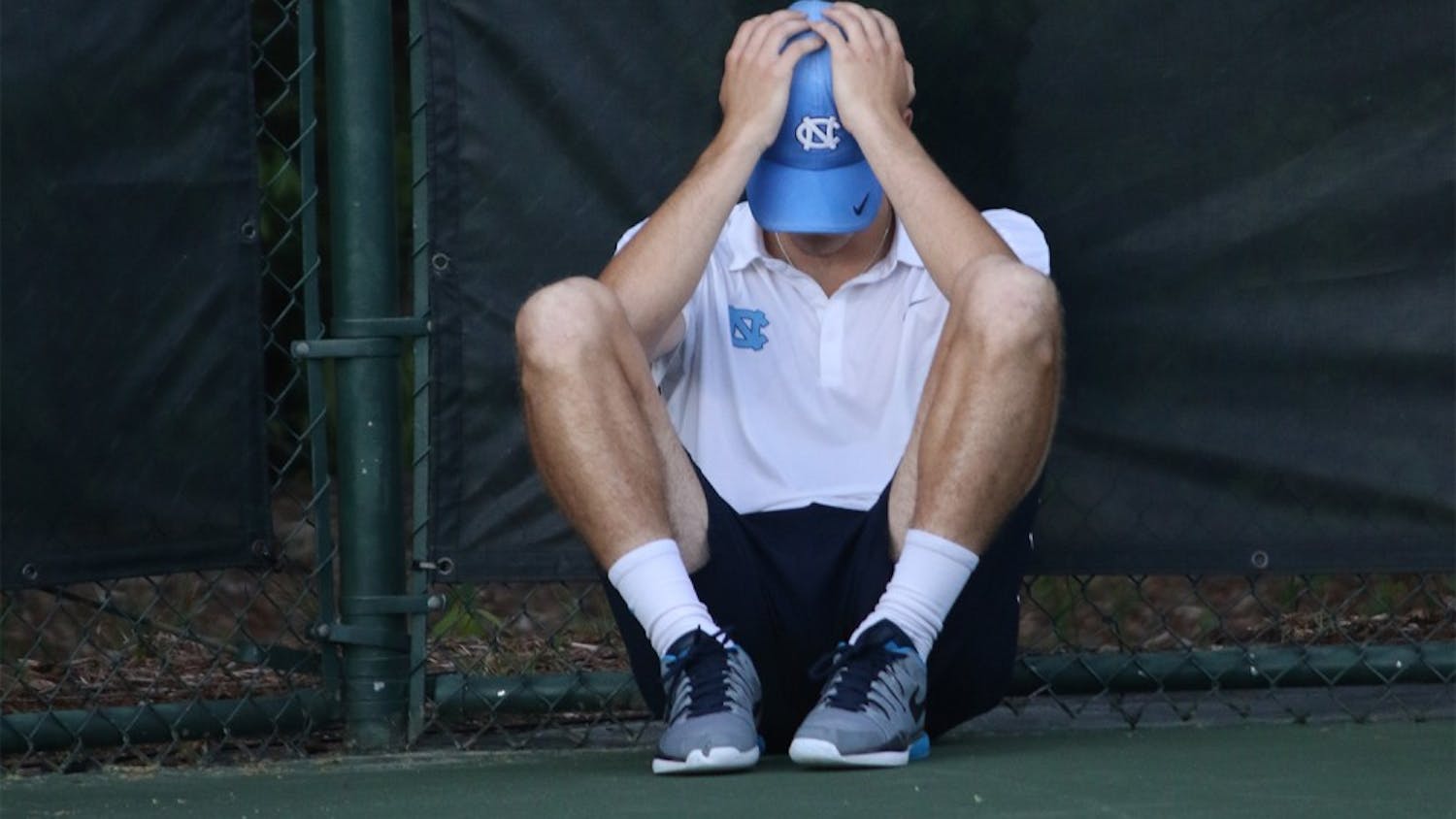 Sophomore Robert Kelly sits in isolation after losing 7-5 in a vital tiebreaker in the third set of his singles match. The UNC men's tennis team lost 4-3 to the University of Virginia in the AC semi-finals on Saturday.
