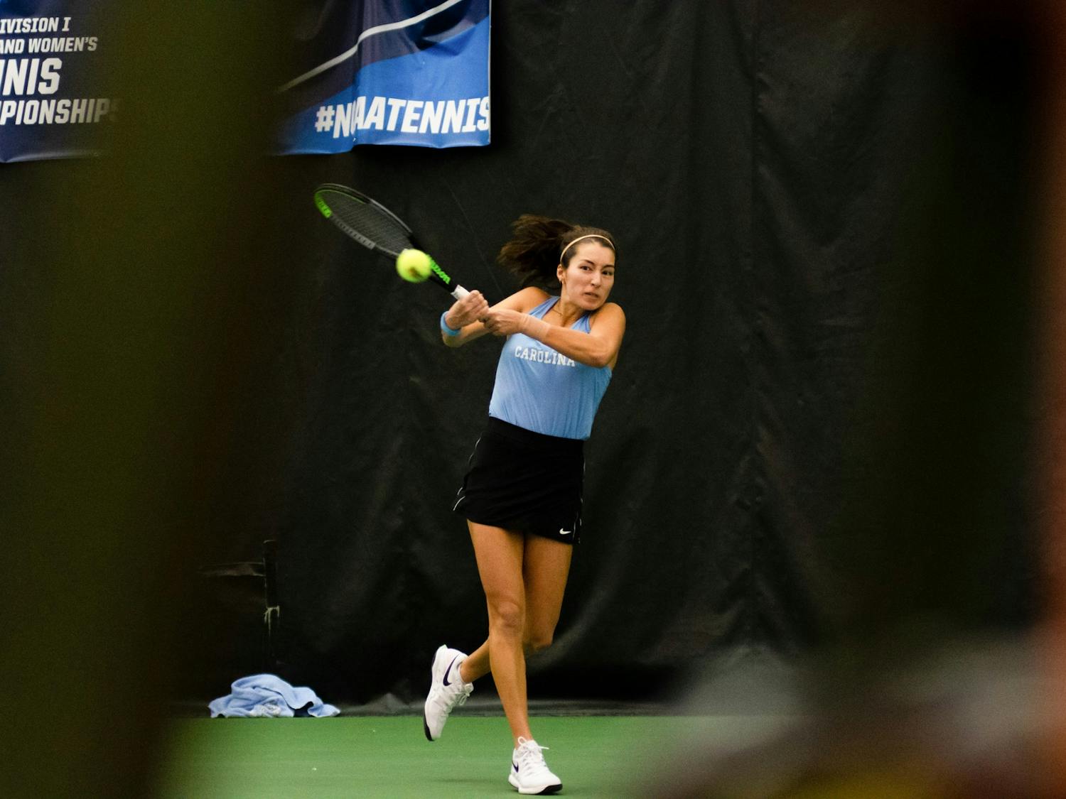 Reilly Tran hits the ball during her singles match against Elon University's Victoria Saldh on Saturday, Jan. 15, 2022, in Chapel Hill, NC.