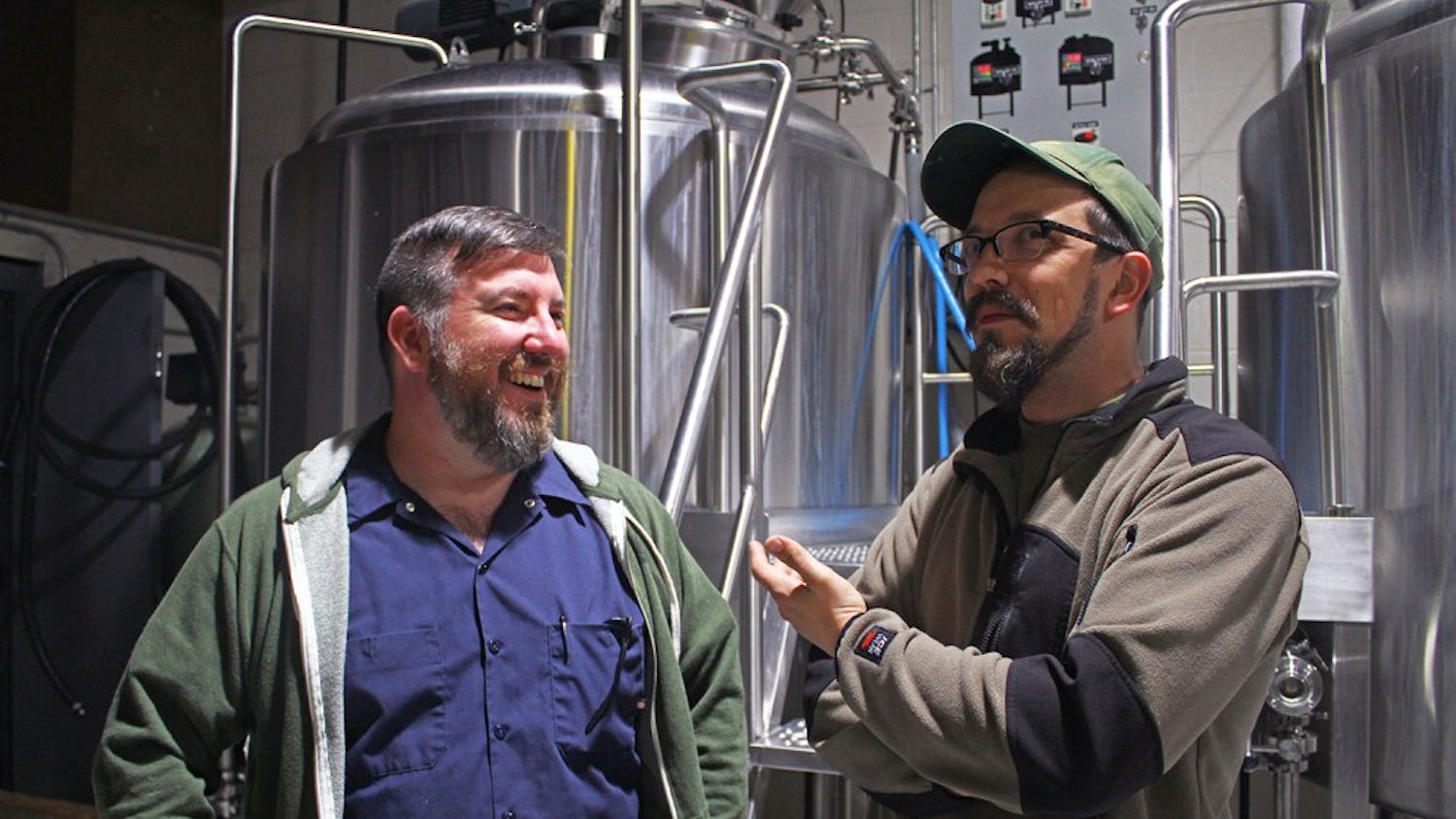 Erik Myers (left), founder of Mystery Brewing, and Keil Jansen, brewmaster of Ponysaurus Brewing Company, are joining with breweries to make a new beer.