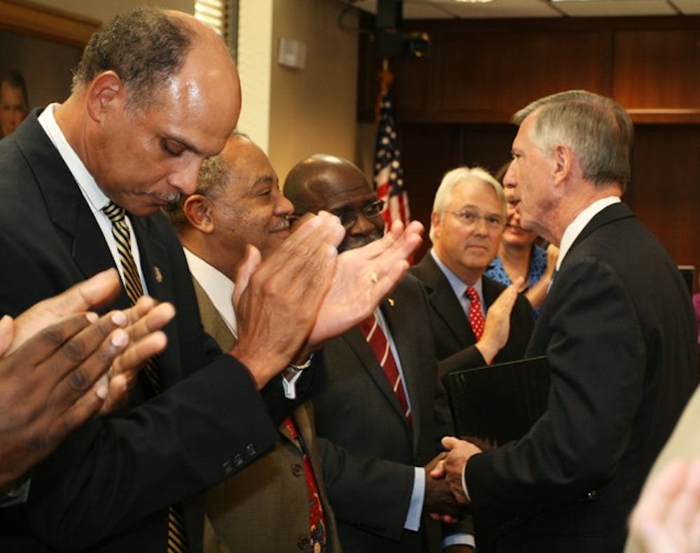 Ross shakes hands with UNC-system chancellors after being elected.