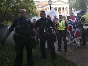 Police from across North Carolina quickly escort demonstrators from McCorkle Place after their scheduled demonstration on Saturday, Sept. 8, 2019. Among them is Sergeant Svetlana Bostelman. Silent Sam activist Julia Pulawksi filed a motion that Bostelman gave false testimony that led to Pulawksi's conviction.
