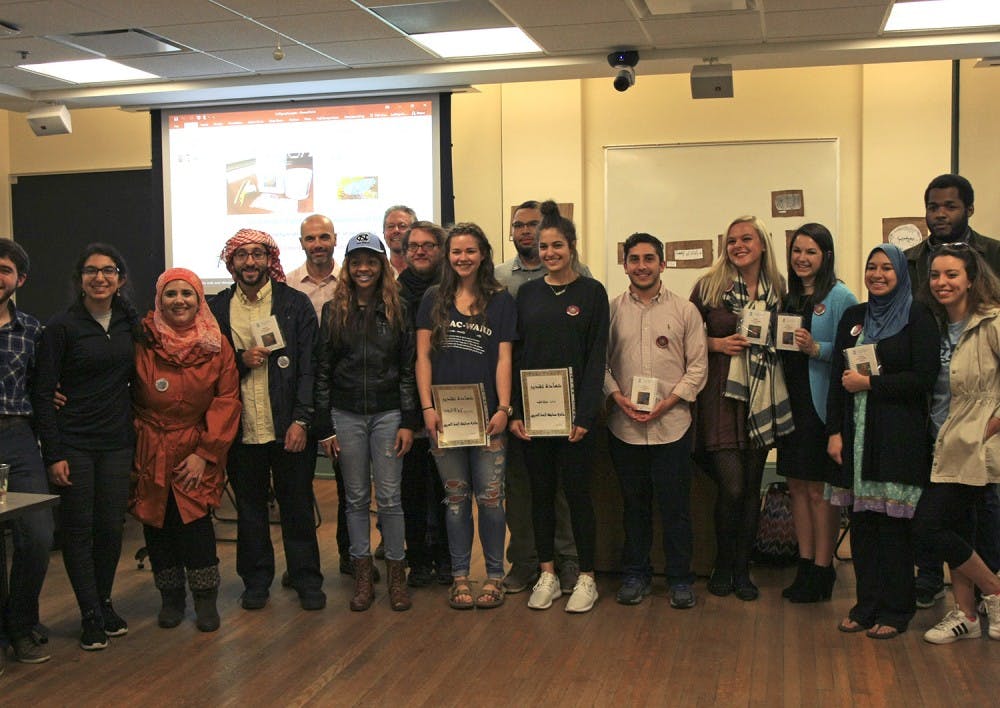 Participants in the first ever calligraphy contest at UNC line up after receiving their prizes for creating their works of calligraphy. 