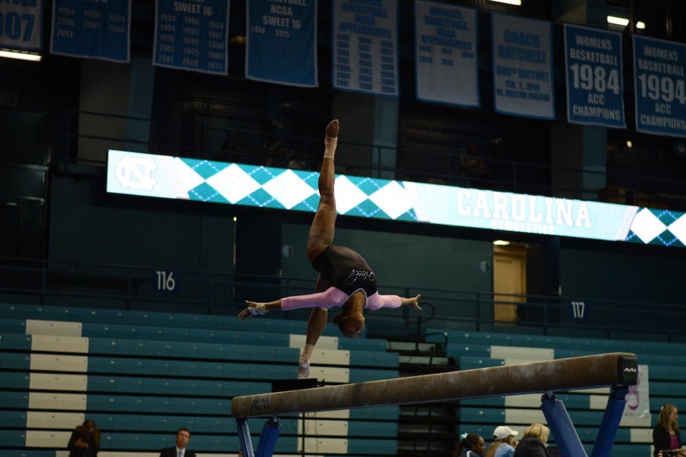 <p>Khazia Hislop performs her beam routine at the annual Pink Meet in February 2017.</p>