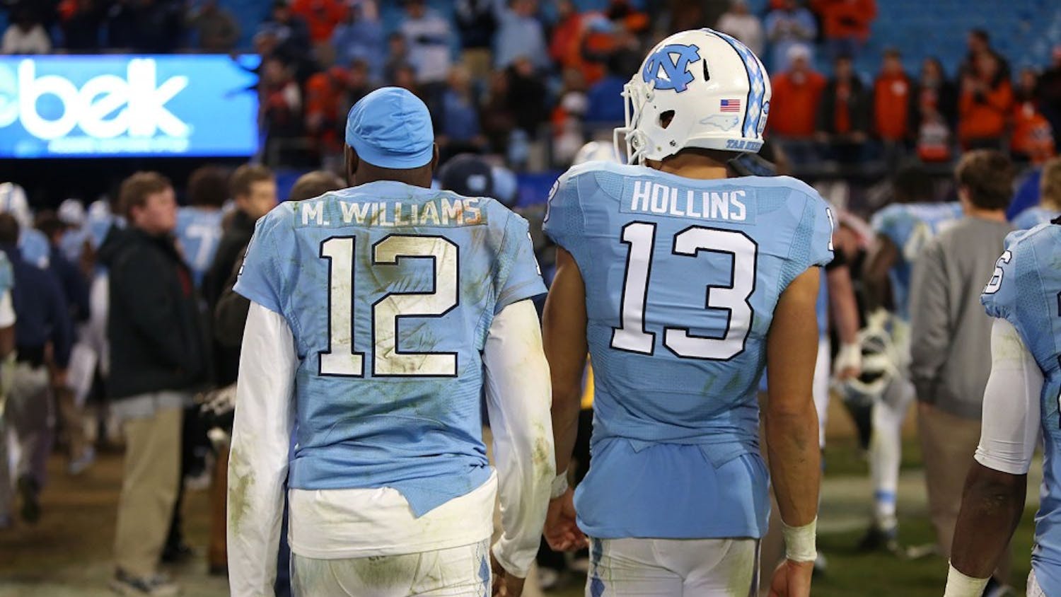 Marquise Williams (12) and Mack Hollins (13) walk back to the Carolina locker room at the conclusion of the game.&nbsp;