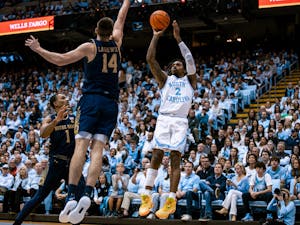 UNC junior Caleb Love (2) shoots a three during the second half of the basketball game against Notre Dame on Saturday, Jan. 7, 2023. UNC won 81-64 at the Smith Center.