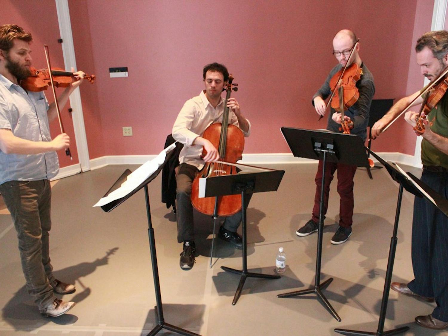 Brooklyn Rider Quartet, pictured Thursday rehearsing at Gerrard Hall, performs on Sunday at Memorial Hall. Members (left to right) Johnny Gandelsman, Eric Jacobsen, Nicholas Cards, and Colin Jacobsen are glad to be back at Carolina for their tenth year; "Music is more than notes on a page, it's life," commented C. Jacobsen on music and its discussion within the university.