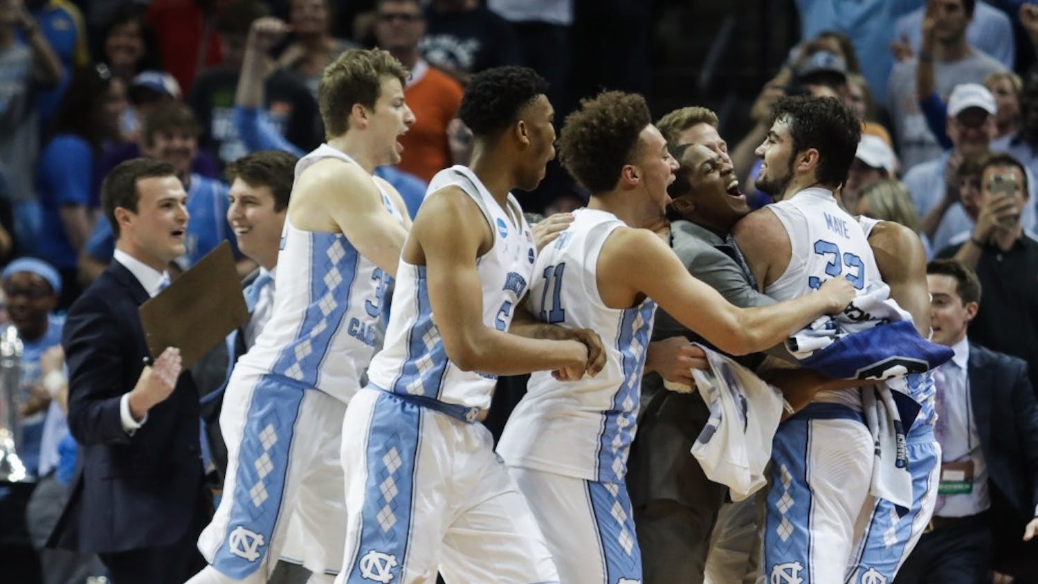 The UNC basketball team swarms Luke Maye (32) after winning  the NCAA Elite Eight game against Kentucky in Memphis on Sunday.