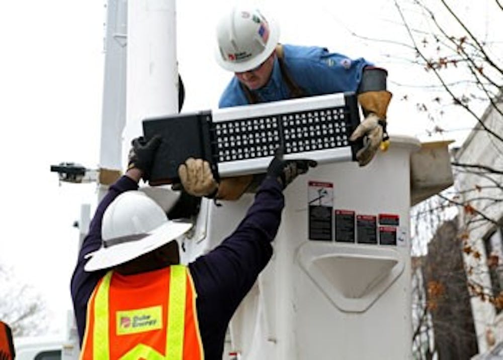 <p>Duke Energy workers install one of 10 LED streetlights on Franklin Street in 2012 as part of a 12-month pilot program to evaluate the effectiveness of the LED lamps in increasing safety at night. The lamps are also expected to last longer and lower carbon emissions.</p>