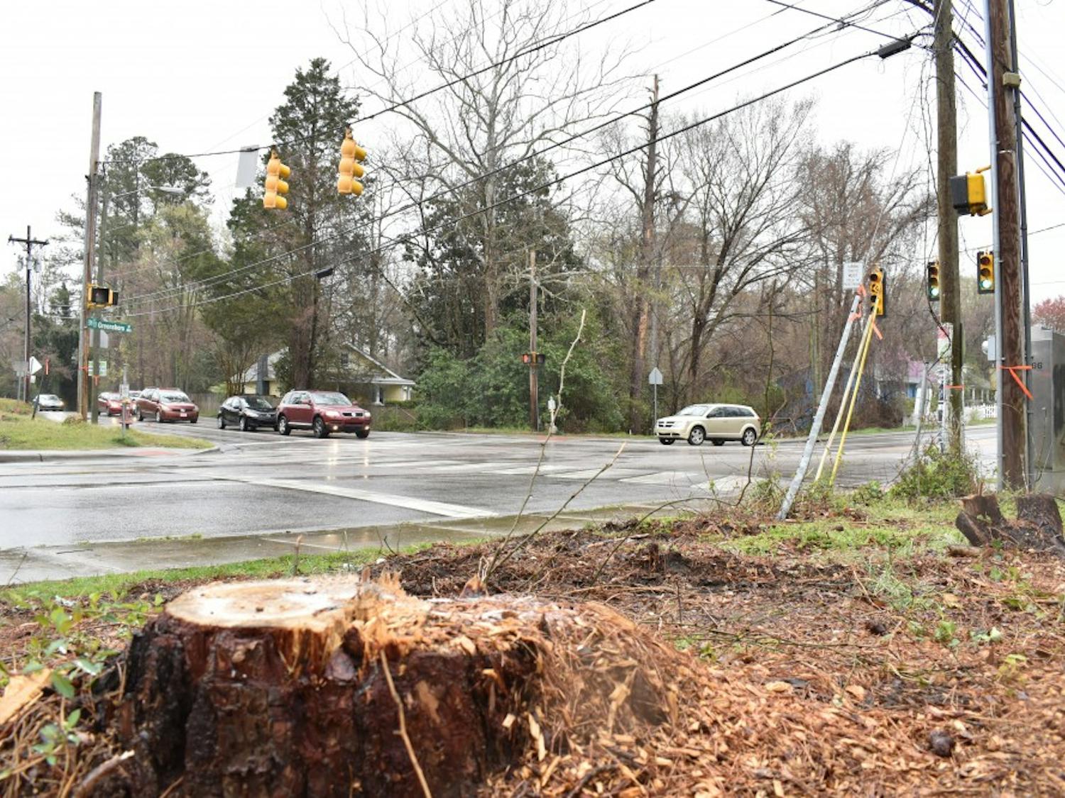 At the intersection of Estes Dr. and North Greensboro St. trees have been cut down and power lines are being relocated as the city of Carrboro is starting to prepare for construction on a roundabout on that intersection. Photographed on April 2, 2019.